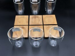 A Set Of 6 Bamboo Coaters/ Trays With 6 Doublewalled Thermo Glasses To Match